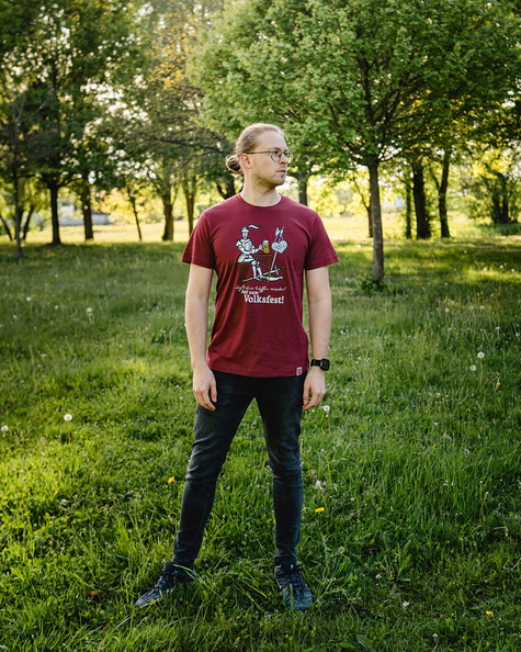 Person steht im Grünen und trägt das rote T-Shirt mit Ritter